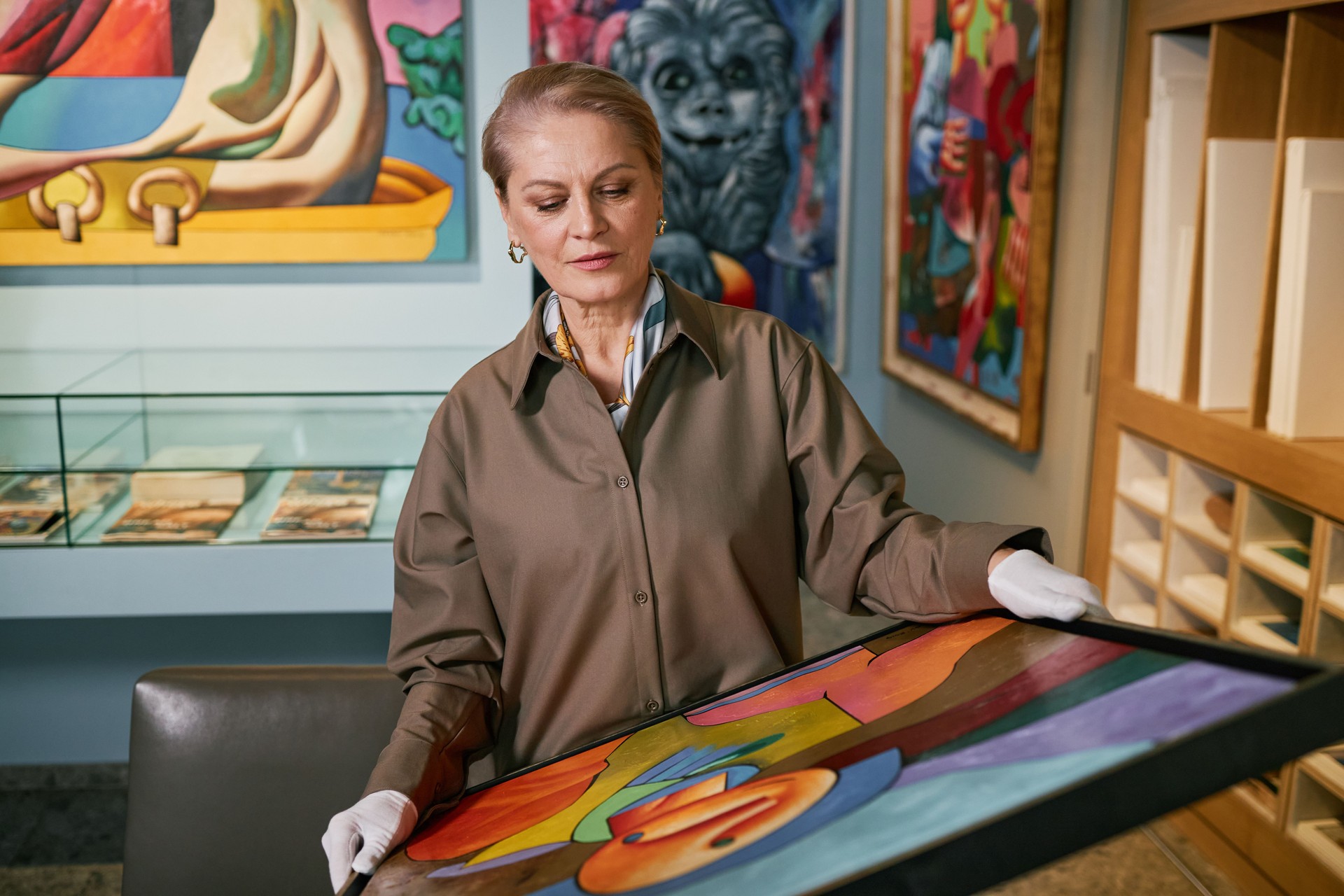 Elderly Woman Rotating Colorful Painting in Art Gallery